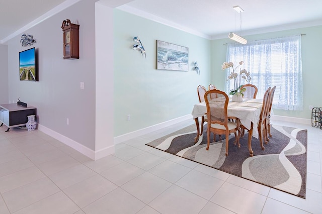 dining room with baseboards, ornamental molding, and light tile patterned flooring