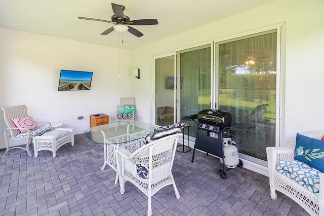 view of patio / terrace with a ceiling fan, outdoor dining space, and a grill