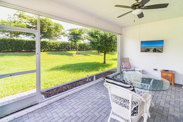 sunroom featuring a ceiling fan