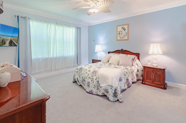 bedroom featuring carpet flooring, crown molding, and ceiling fan