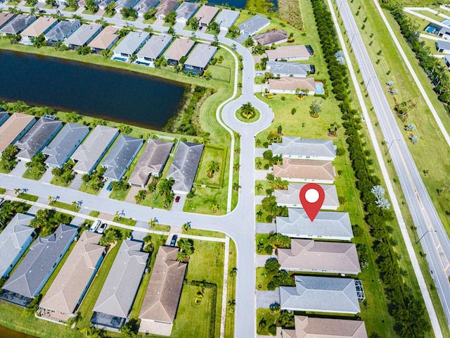 birds eye view of property featuring a water view and a residential view