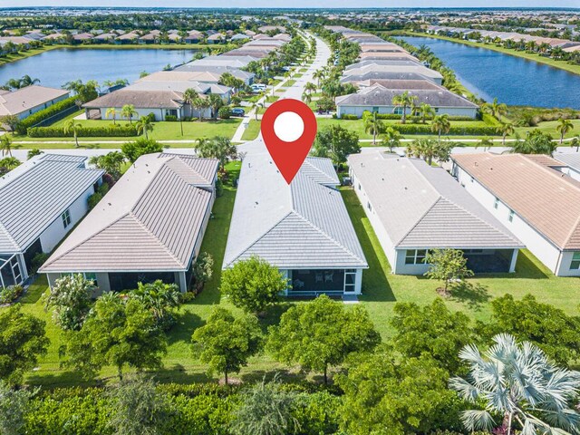 birds eye view of property featuring a water view and a residential view