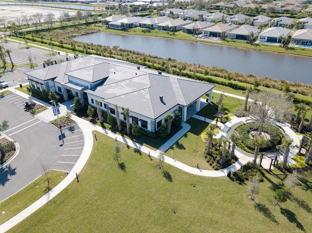 birds eye view of property with a water view and a residential view