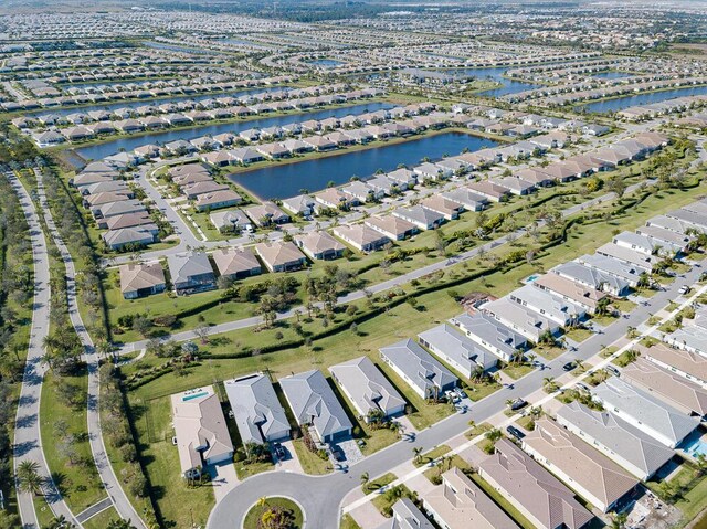 drone / aerial view with a water view and a residential view