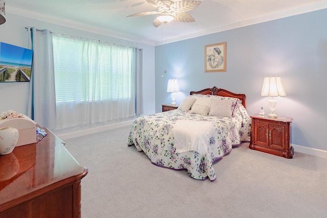 bedroom featuring baseboards, carpet floors, a ceiling fan, and crown molding