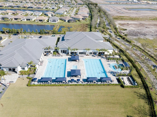 birds eye view of property with a water view and a residential view