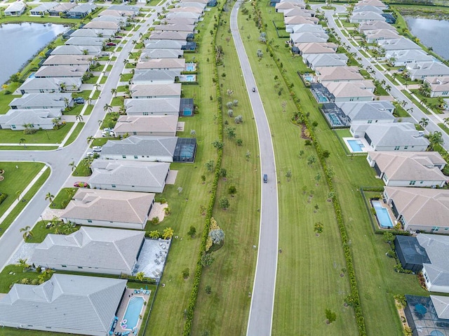 bird's eye view featuring a water view and a residential view