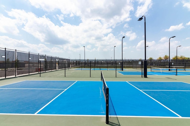 view of sport court featuring fence