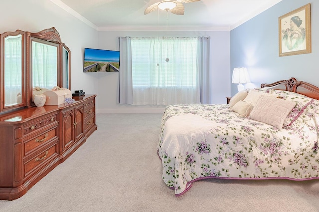 bedroom with crown molding, a ceiling fan, and light colored carpet