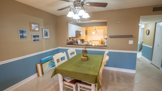 dining space featuring ceiling fan and light tile patterned flooring