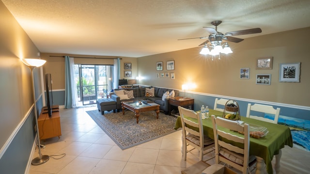 tiled living room with a textured ceiling and ceiling fan