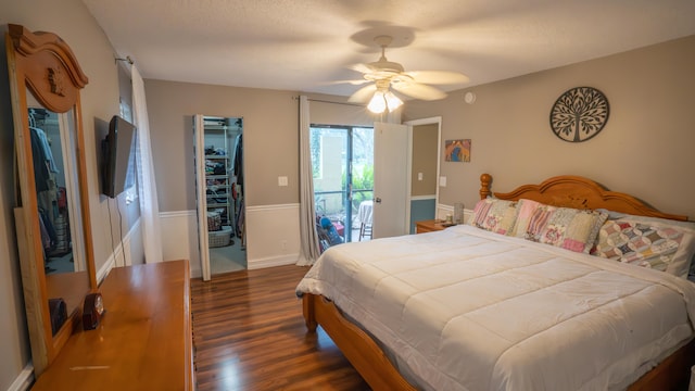 bedroom featuring ceiling fan, access to outside, and dark hardwood / wood-style flooring