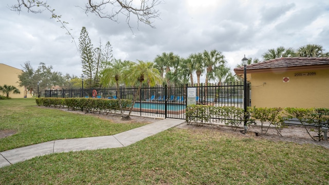 view of pool with a yard