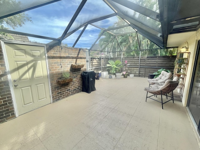 view of patio / terrace featuring glass enclosure