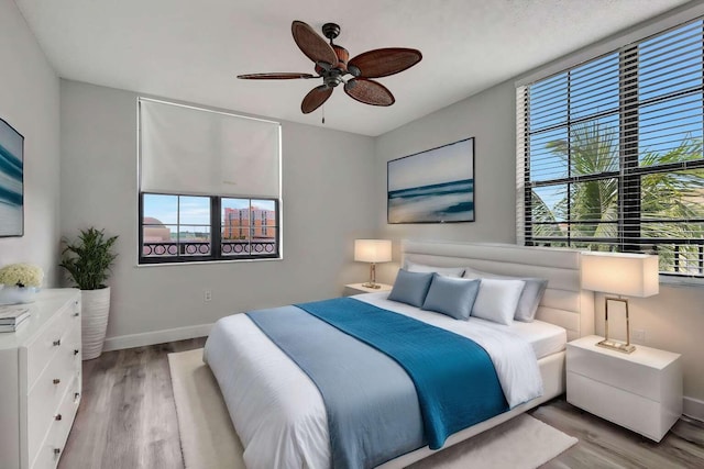 bedroom with ceiling fan and light wood-type flooring