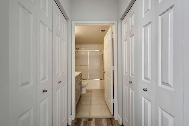 corridor featuring wood-type flooring