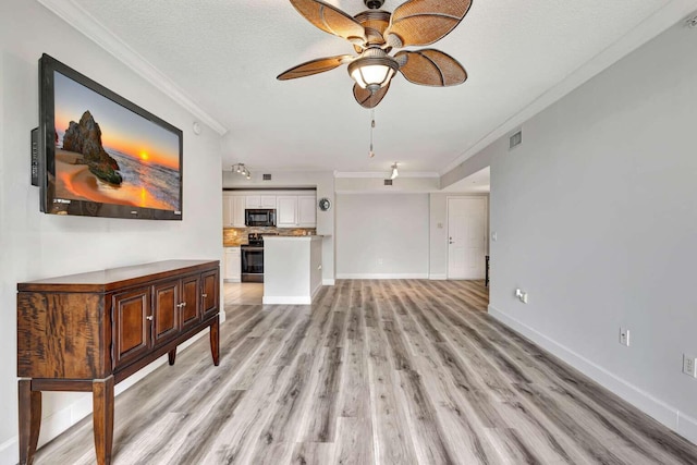 living room featuring ceiling fan, light hardwood / wood-style floors, a textured ceiling, and ornamental molding