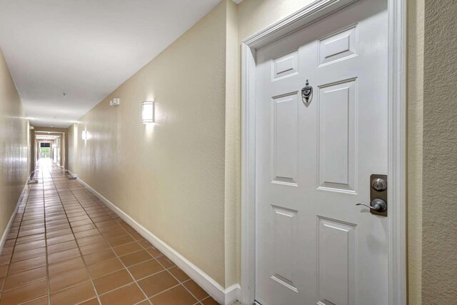 hallway with tile patterned flooring