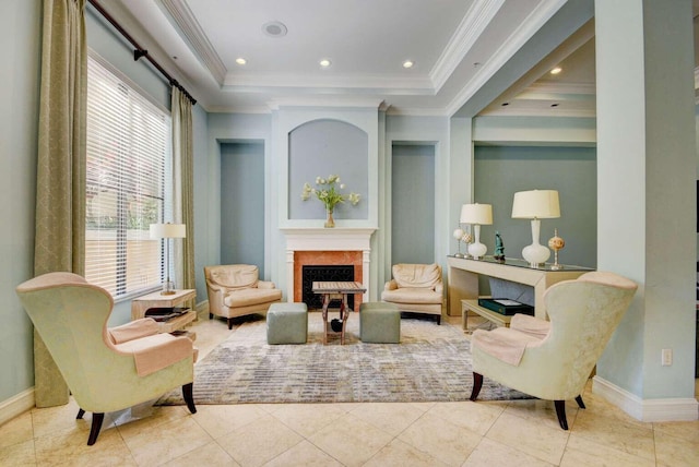 sitting room with a tray ceiling, ornamental molding, a high end fireplace, and light tile patterned floors