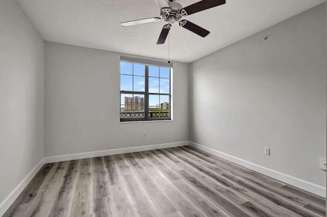 unfurnished room with hardwood / wood-style floors, a textured ceiling, and ceiling fan