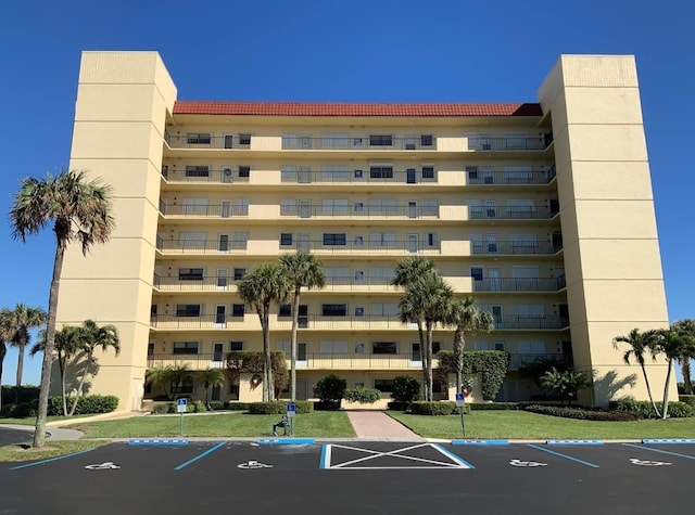 view of building exterior featuring uncovered parking