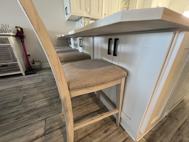 interior space featuring baseboards and wood finished floors