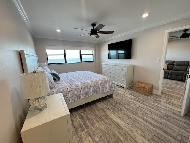 bedroom with ceiling fan, crown molding, and hardwood / wood-style floors