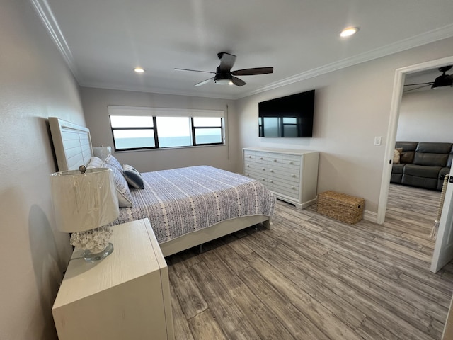 bedroom with ceiling fan, recessed lighting, wood finished floors, baseboards, and ornamental molding