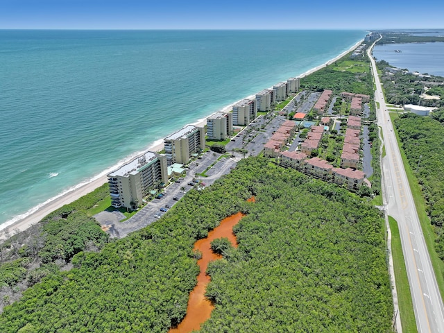 bird's eye view featuring a water view and a beach view