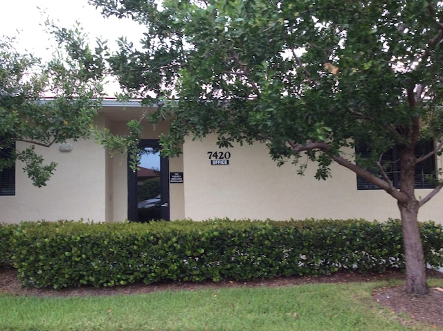 view of side of property featuring stucco siding