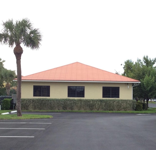 view of property featuring uncovered parking