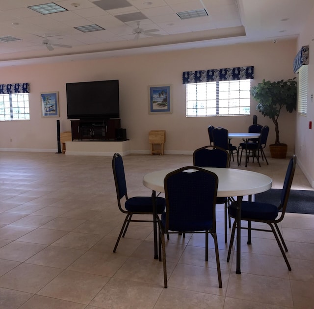 dining room with plenty of natural light, a raised ceiling, visible vents, and ceiling fan