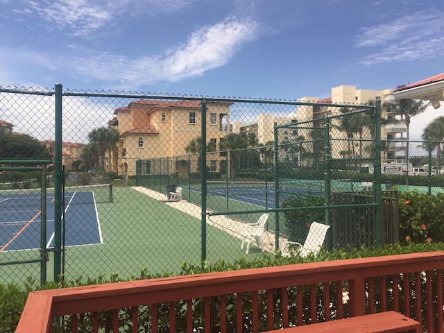 view of tennis court with fence