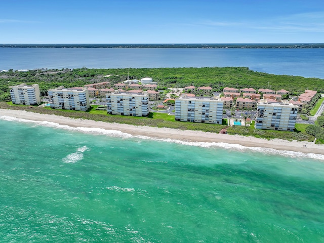 drone / aerial view with a beach view and a water view