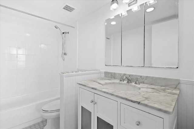 full bathroom with tile patterned floors, toilet, vanity, and tiled shower / bath