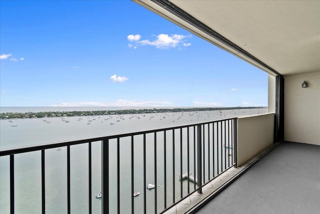 balcony featuring a water view and a beach view