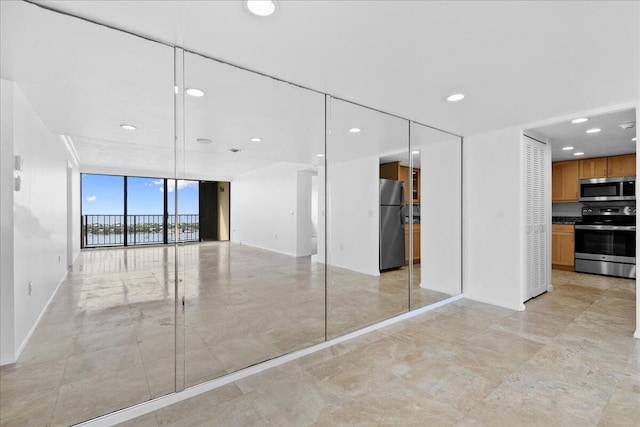 interior space with light tile patterned flooring and expansive windows