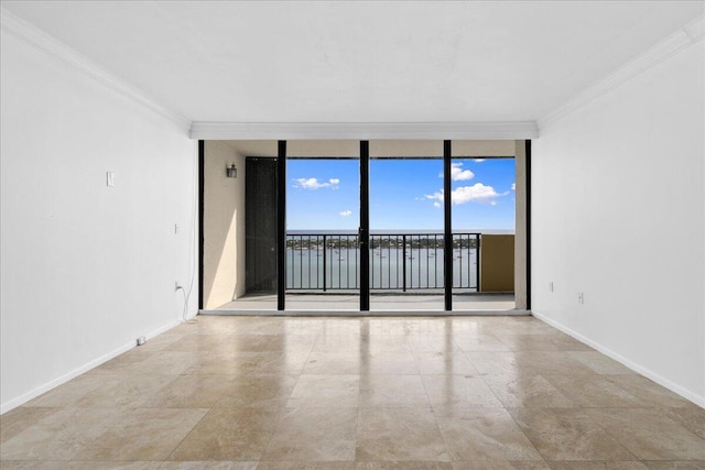 empty room with a wall of windows, crown molding, and light tile patterned floors