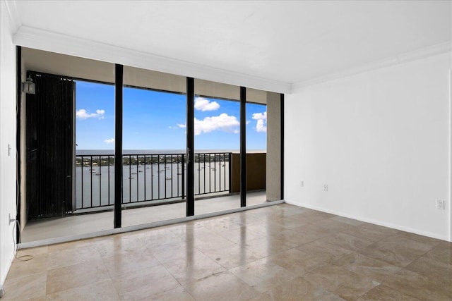 empty room featuring ornamental molding, a wall of windows, and tile patterned flooring