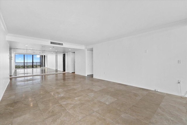 empty room with light tile patterned floors, expansive windows, and crown molding