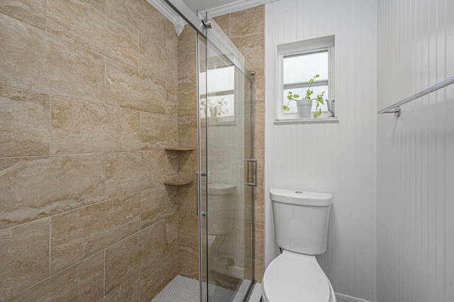 bathroom featuring walk in shower, ornamental molding, and toilet