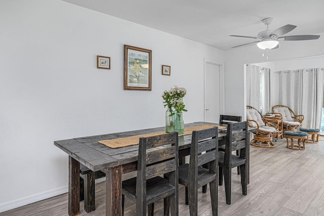 dining area with ceiling fan and hardwood / wood-style floors