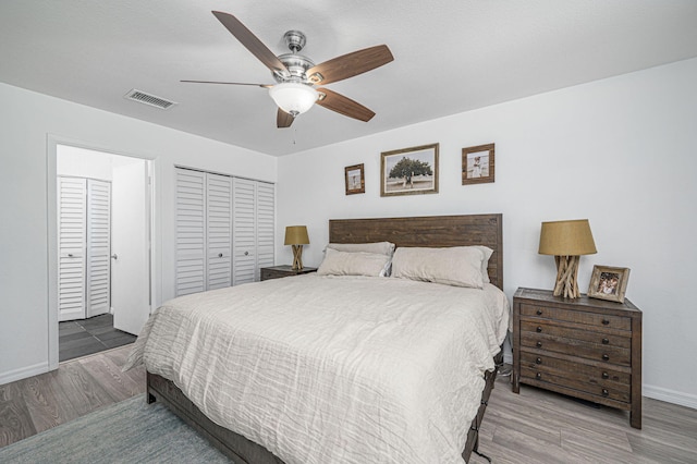 bedroom featuring ceiling fan, a closet, and hardwood / wood-style flooring