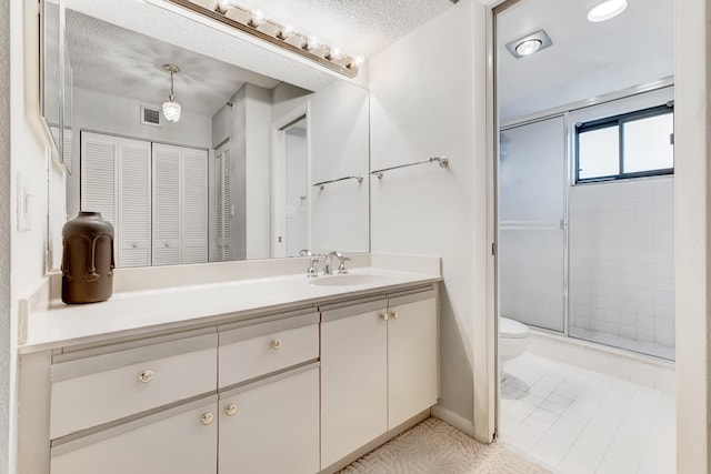 bathroom featuring walk in shower, a textured ceiling, toilet, tile patterned floors, and vanity