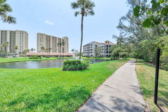 view of home's community with a yard and a water view