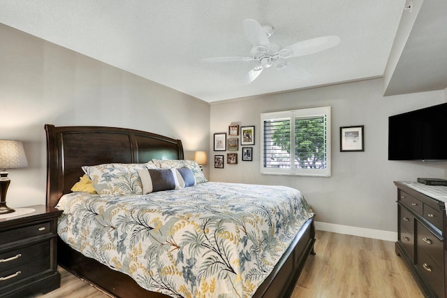 bedroom with light hardwood / wood-style floors and ceiling fan