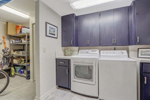 laundry room featuring cabinets and washer and dryer