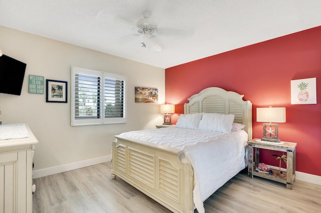 bedroom with ceiling fan and light wood-type flooring