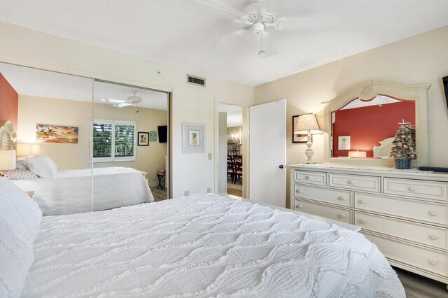 bedroom with ceiling fan, wood-type flooring, and a closet