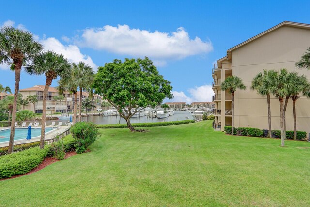 view of yard featuring a balcony and a community pool